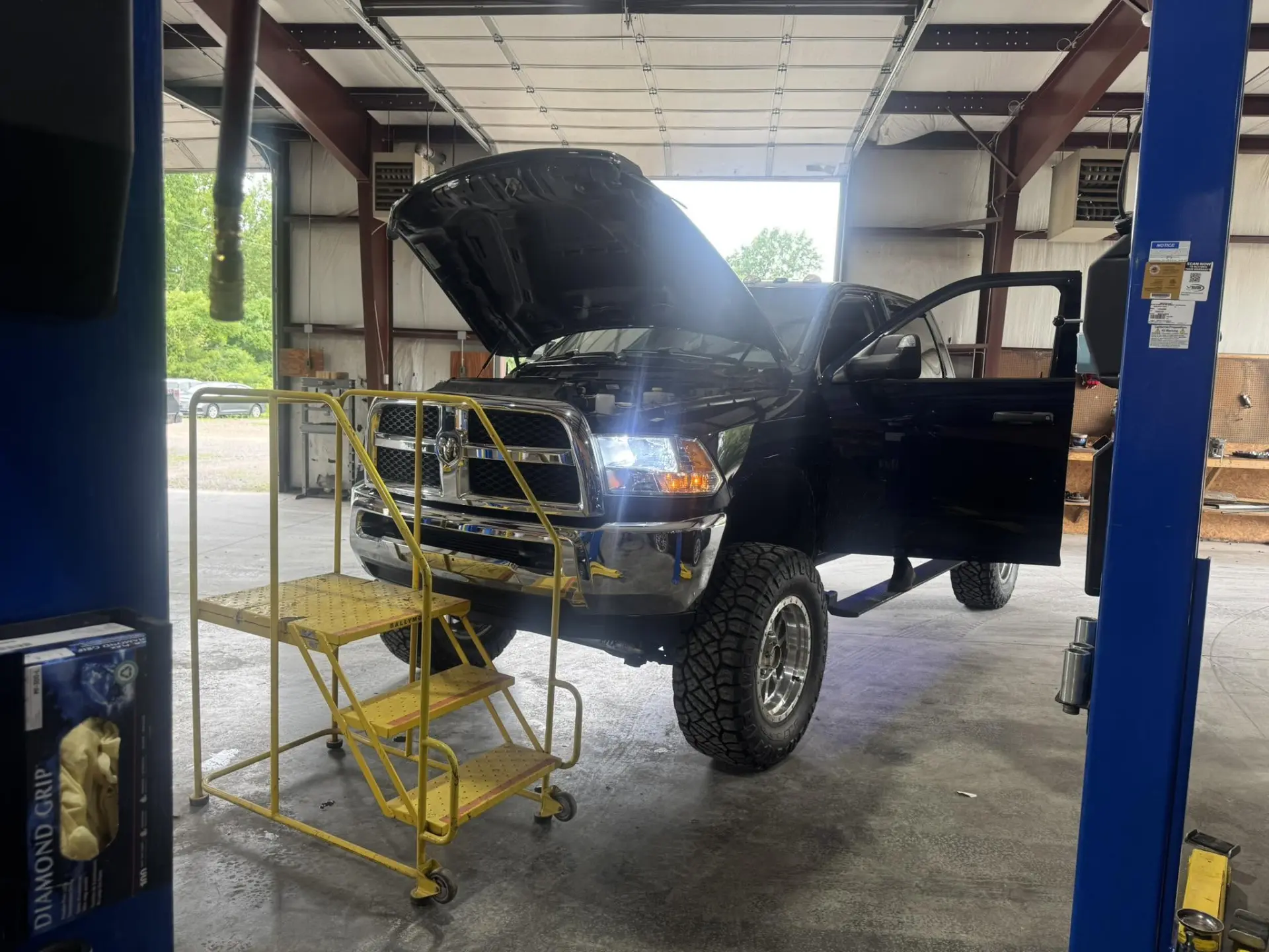 Lifted Ram 2500 truck on a lift for diagnostics and repair