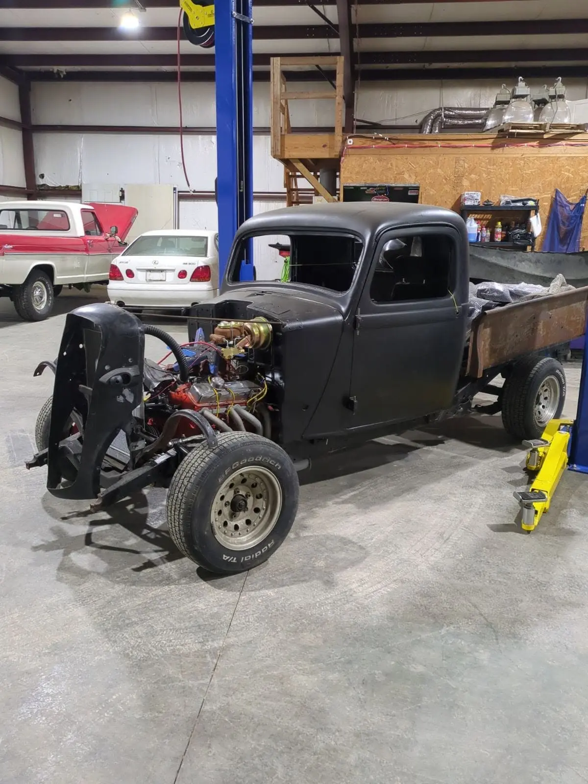 Vintage pickup truck restoration project with engine work in progress